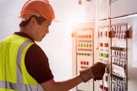 Electrician at control panel